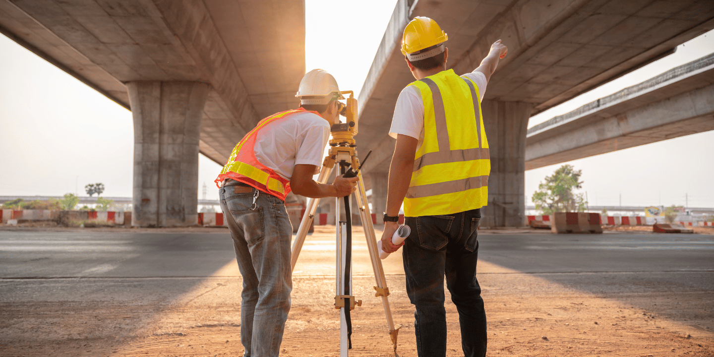 Two civil engineers working under an overpass